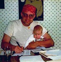 Dr. Berg holding baby.